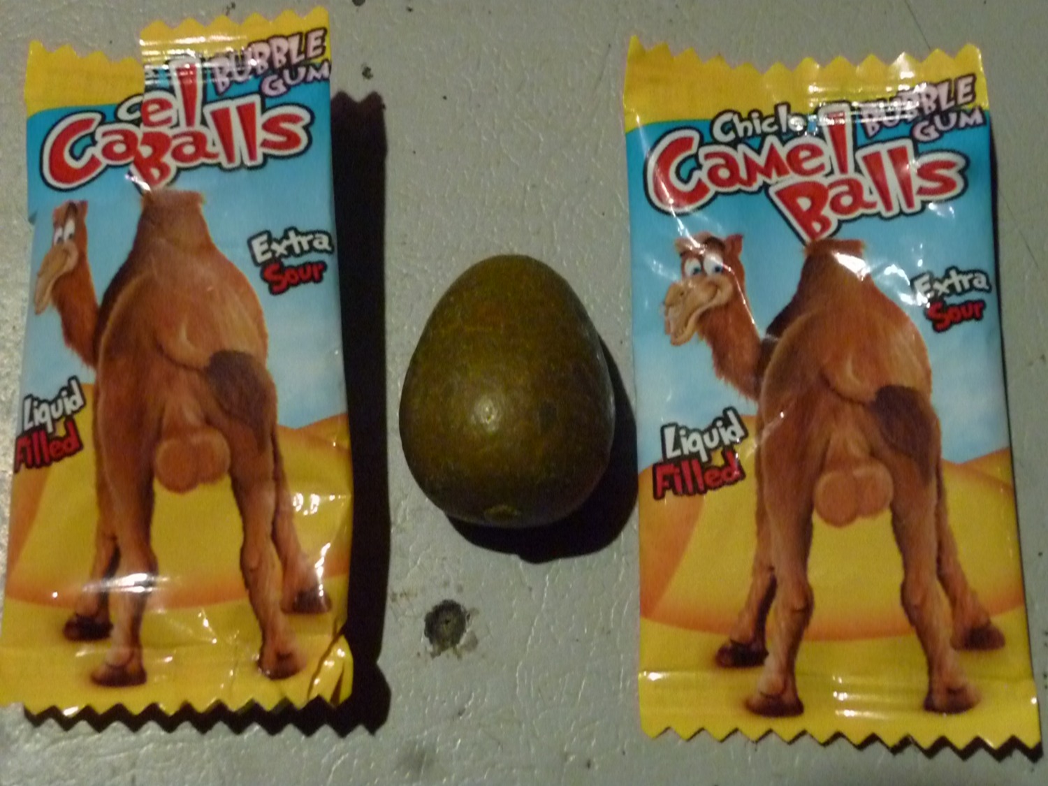 4:3 balls bubble_gum camel camelid dromedary e621 fatty_humps feral fini_(candy) genitals grandfathered_content hi_res hooves looking_at_viewer male mammal package photography_(artwork) real solo toony unguligrade unknown_artist why